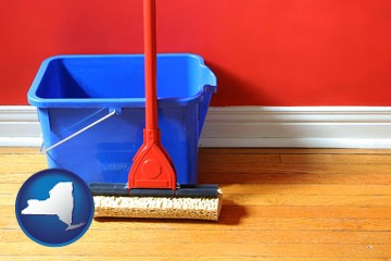 a bucket and mop on a hardwood floor - with New York icon