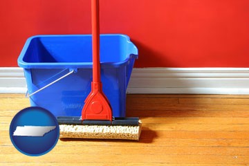 a bucket and mop on a hardwood floor - with Tennessee icon