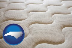 north-carolina map icon and a mattress surface