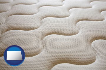 a mattress surface - with North Dakota icon