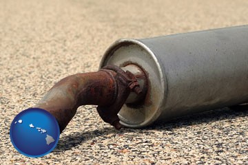 a rusty muffler and tailpipe - with Hawaii icon