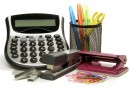office supplies: calculator, paper clips, pens, scissors, stapler, and staples