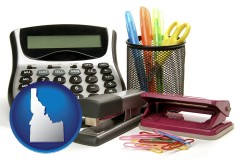 idaho map icon and office supplies: calculator, paper clips, pens, scissors, stapler, and staples