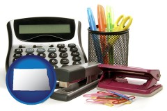 north-dakota map icon and office supplies: calculator, paper clips, pens, scissors, stapler, and staples