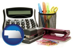 nebraska map icon and office supplies: calculator, paper clips, pens, scissors, stapler, and staples