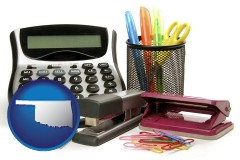 oklahoma map icon and office supplies: calculator, paper clips, pens, scissors, stapler, and staples