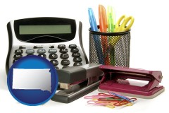 south-dakota map icon and office supplies: calculator, paper clips, pens, scissors, stapler, and staples