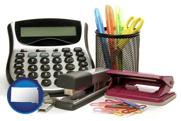 office supplies: calculator, paper clips, pens, scissors, stapler, and staples - with South Dakota icon