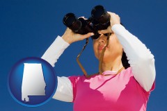 alabama map icon and a woman looking through binoculars