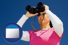 colorado a woman looking through binoculars