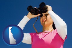 delaware a woman looking through binoculars