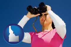 idaho map icon and a woman looking through binoculars