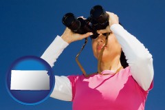 kansas map icon and a woman looking through binoculars