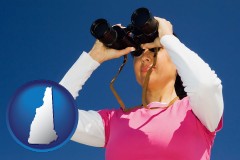 new-hampshire a woman looking through binoculars