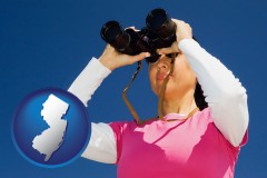 new-jersey map icon and a woman looking through binoculars