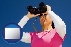 wyoming a woman looking through binoculars