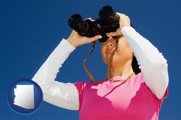 a woman looking through binoculars - with Arizona icon