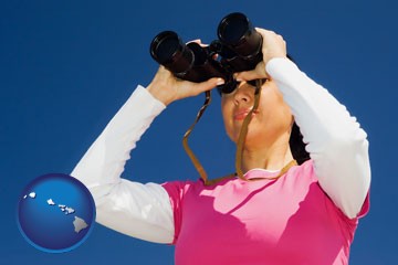 a woman looking through binoculars - with Hawaii icon