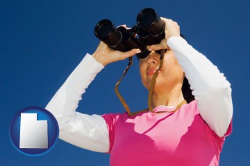 a woman looking through binoculars - with Utah icon