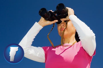 a woman looking through binoculars - with Vermont icon