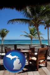 michigan map icon and outdoor furniture on a tropical, oceanfront deck