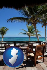 new-jersey map icon and outdoor furniture on a tropical, oceanfront deck