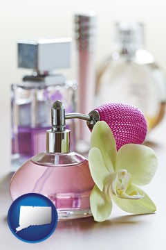a perfume bottle, with atomizer, and an orchid flower - with Connecticut icon