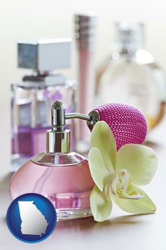 a perfume bottle, with atomizer, and an orchid flower - with Georgia icon