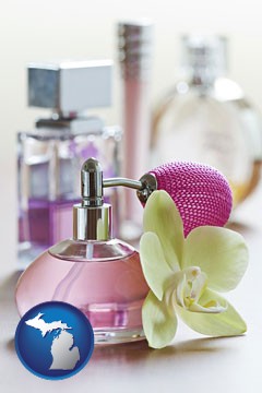 a perfume bottle, with atomizer, and an orchid flower - with Michigan icon
