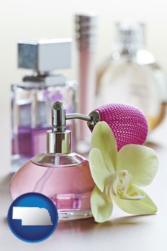 a perfume bottle, with atomizer, and an orchid flower - with Nebraska icon