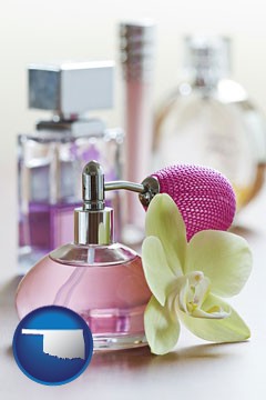 a perfume bottle, with atomizer, and an orchid flower - with Oklahoma icon