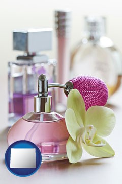 a perfume bottle, with atomizer, and an orchid flower - with Wyoming icon