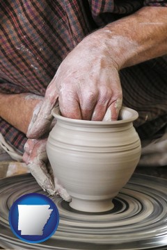 a potter making pottery on a pottery wheel - with Arkansas icon