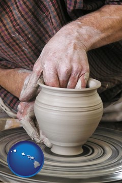 a potter making pottery on a pottery wheel - with Hawaii icon