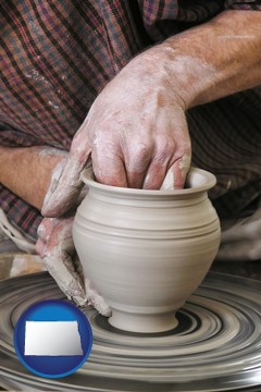 a potter making pottery on a pottery wheel - with North Dakota icon