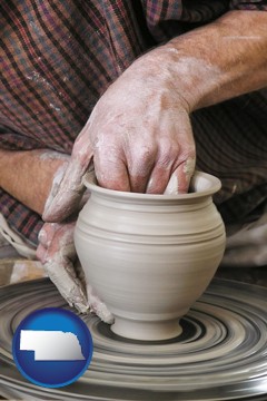 a potter making pottery on a pottery wheel - with Nebraska icon
