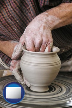 a potter making pottery on a pottery wheel - with Wyoming icon