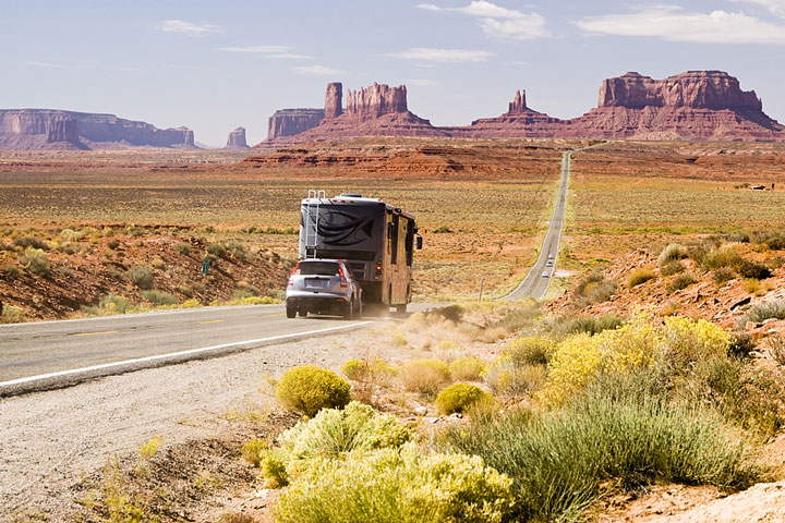 RV towing a car on an Arizona desert highway
