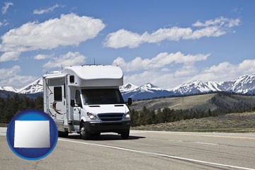 recreational vehicle and snow-capped mountains - with Wyoming icon