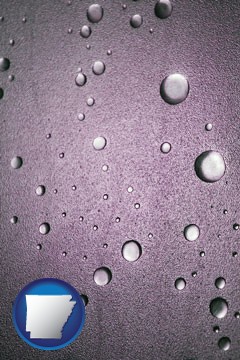 water droplets on a shower door - with Arkansas icon