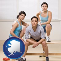 ak map icon and three athletes wearing sportswear