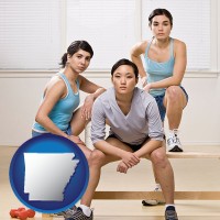 arkansas map icon and three athletes wearing sportswear