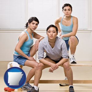 three athletes wearing sportswear - with Arkansas icon