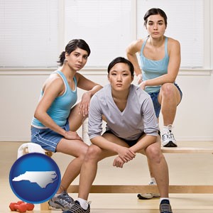 three athletes wearing sportswear - with North Carolina icon