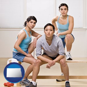 three athletes wearing sportswear - with North Dakota icon
