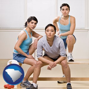 three athletes wearing sportswear - with South Carolina icon
