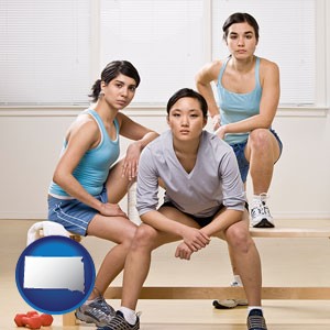three athletes wearing sportswear - with South Dakota icon