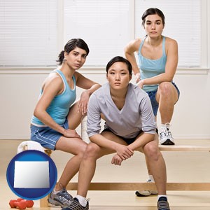 three athletes wearing sportswear - with Wyoming icon