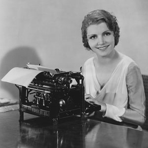 a happy typist using an antique typewriter