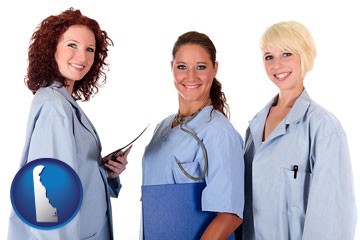 three female doctors wearing hospital uniforms - with Delaware icon